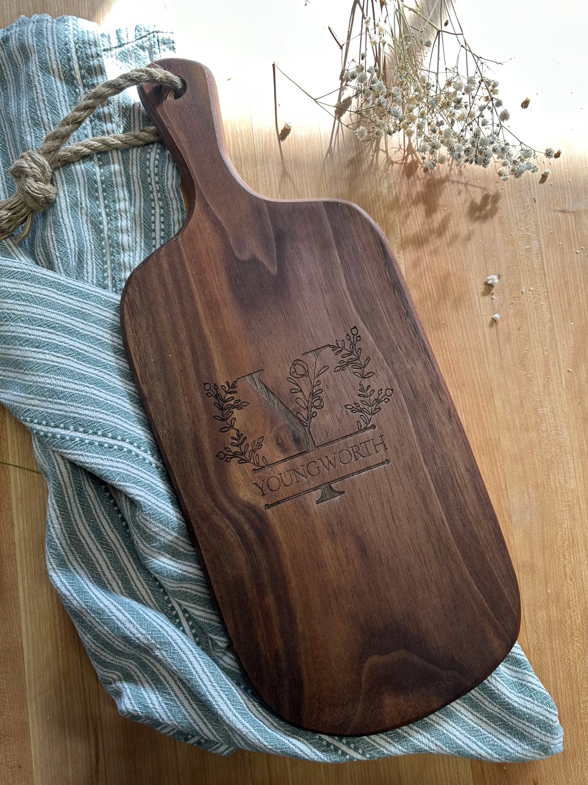 Wooden cutting board with engraved design on a striped cloth