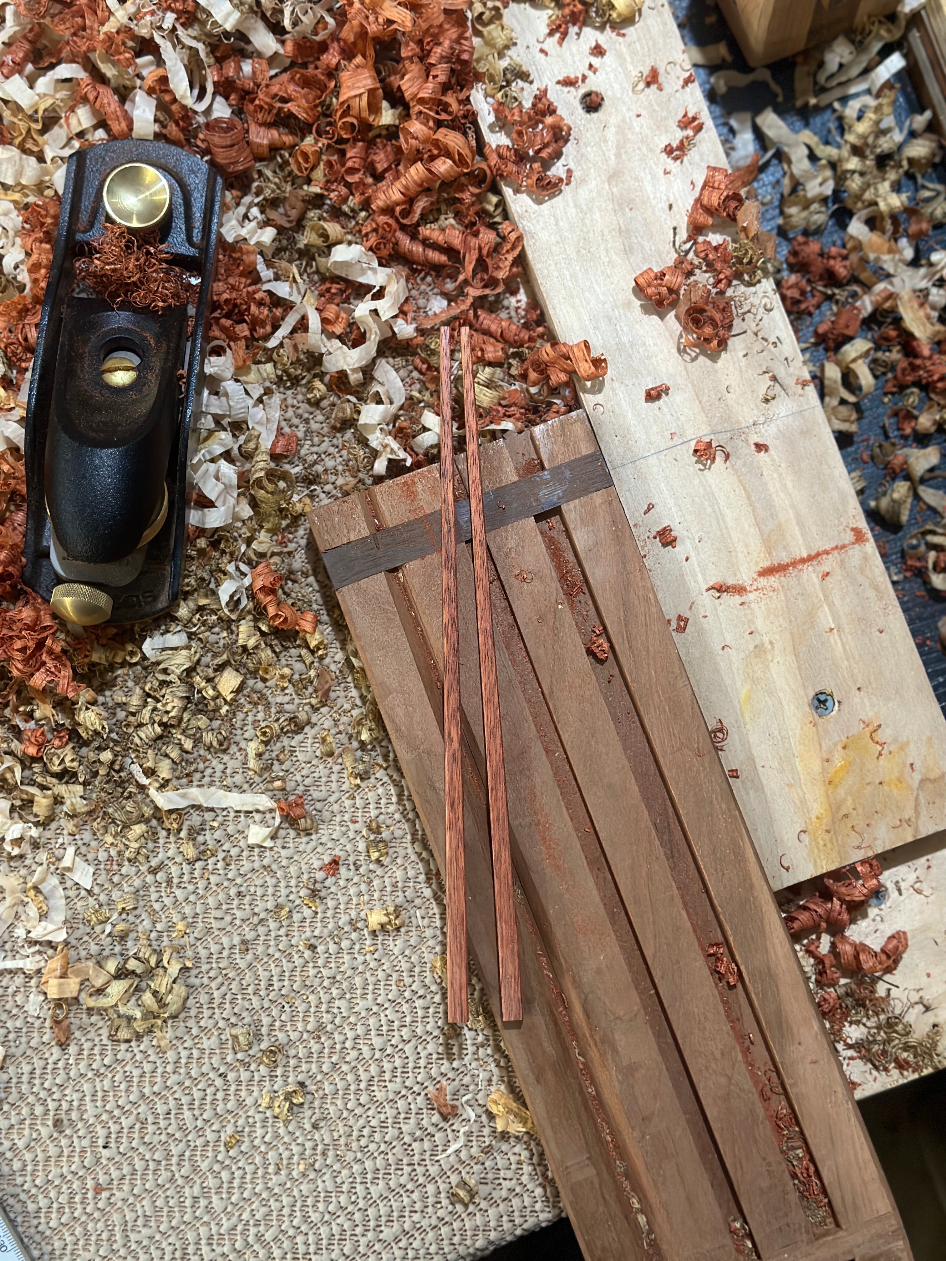 Handcarved wooden chopsticks being made with a hand plane in our workshop